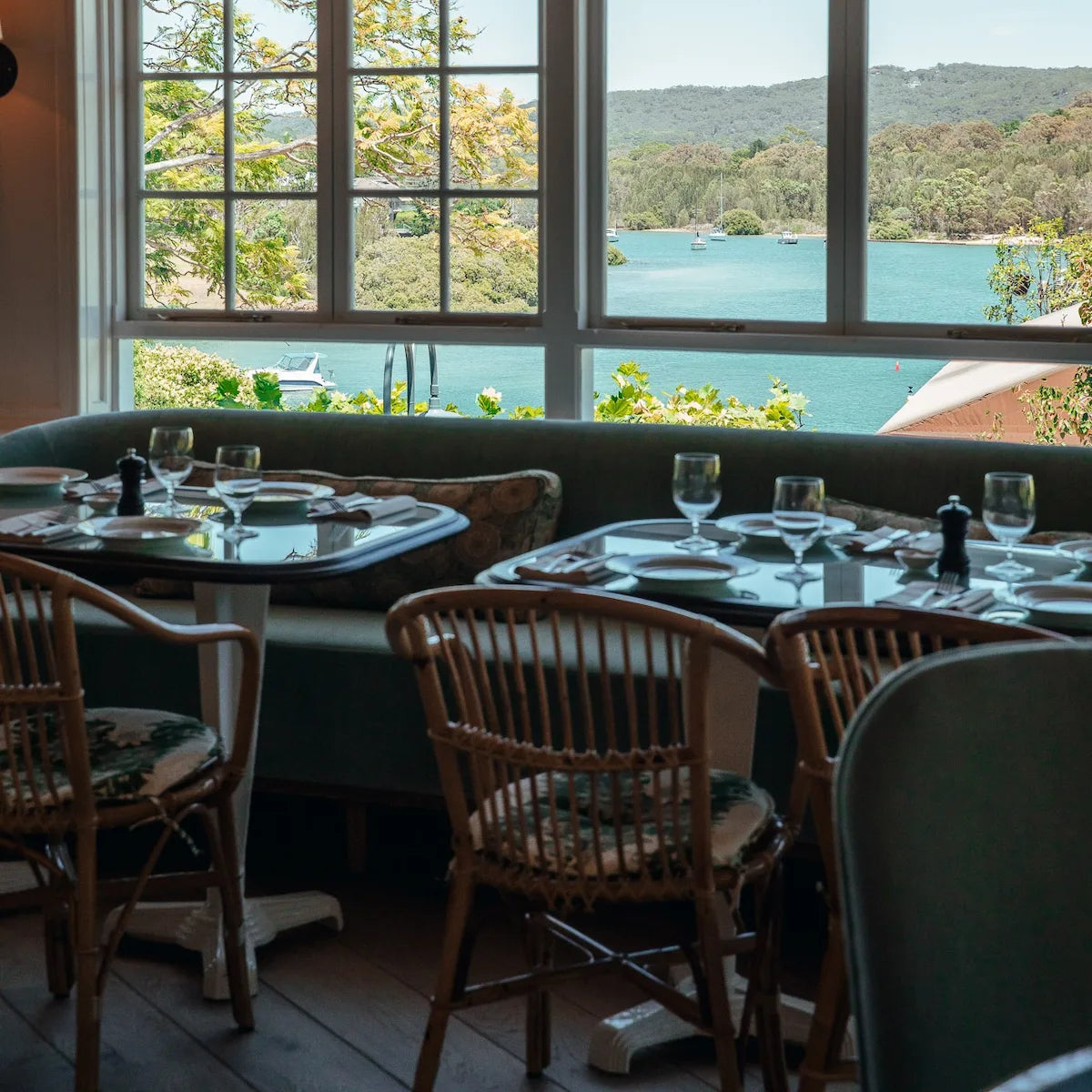 Dining area at Bert's Brasserie at Newport on Sydney's Northern Beaches by large windows overlooking the Pittwater.